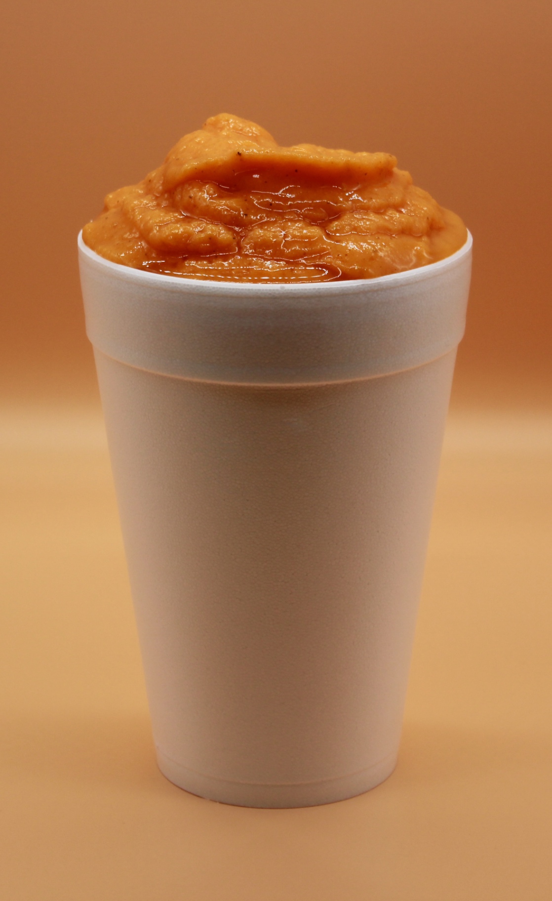 Mango smoothie in a tall cup