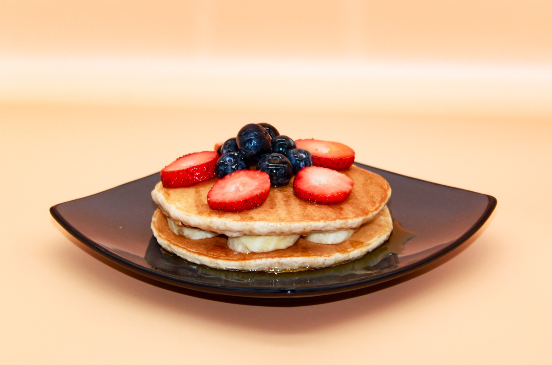 Pancakes with strawberries and blueberries